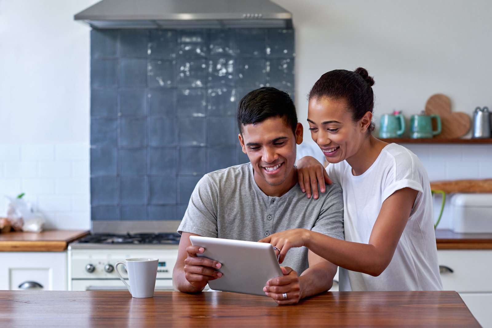 Couple looking at tablet in kitchen