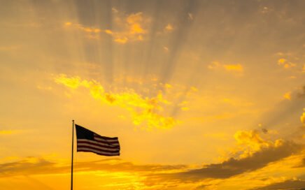 american flag with orange sky background