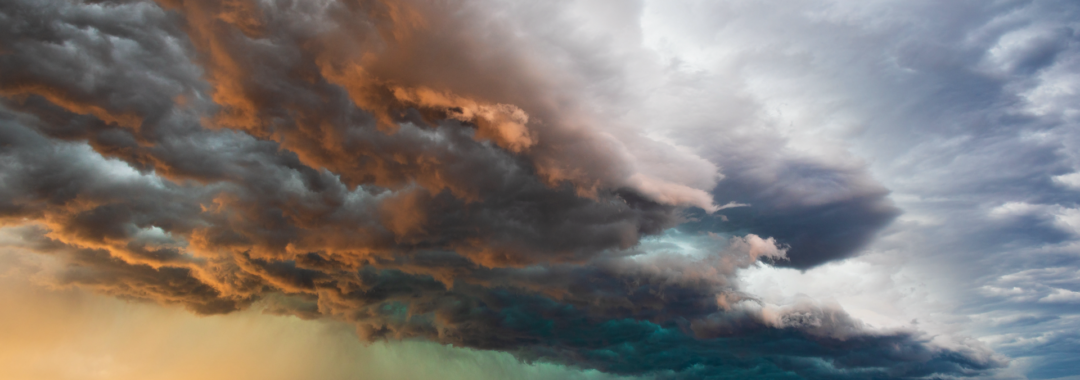 Stormy sky with dramatic clouds from an approaching thunderstorm at sunset
